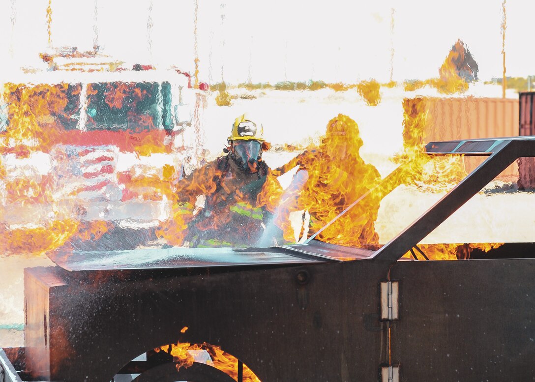 firefighters with the Combat Center Fire Department conduct vehicle fire drills