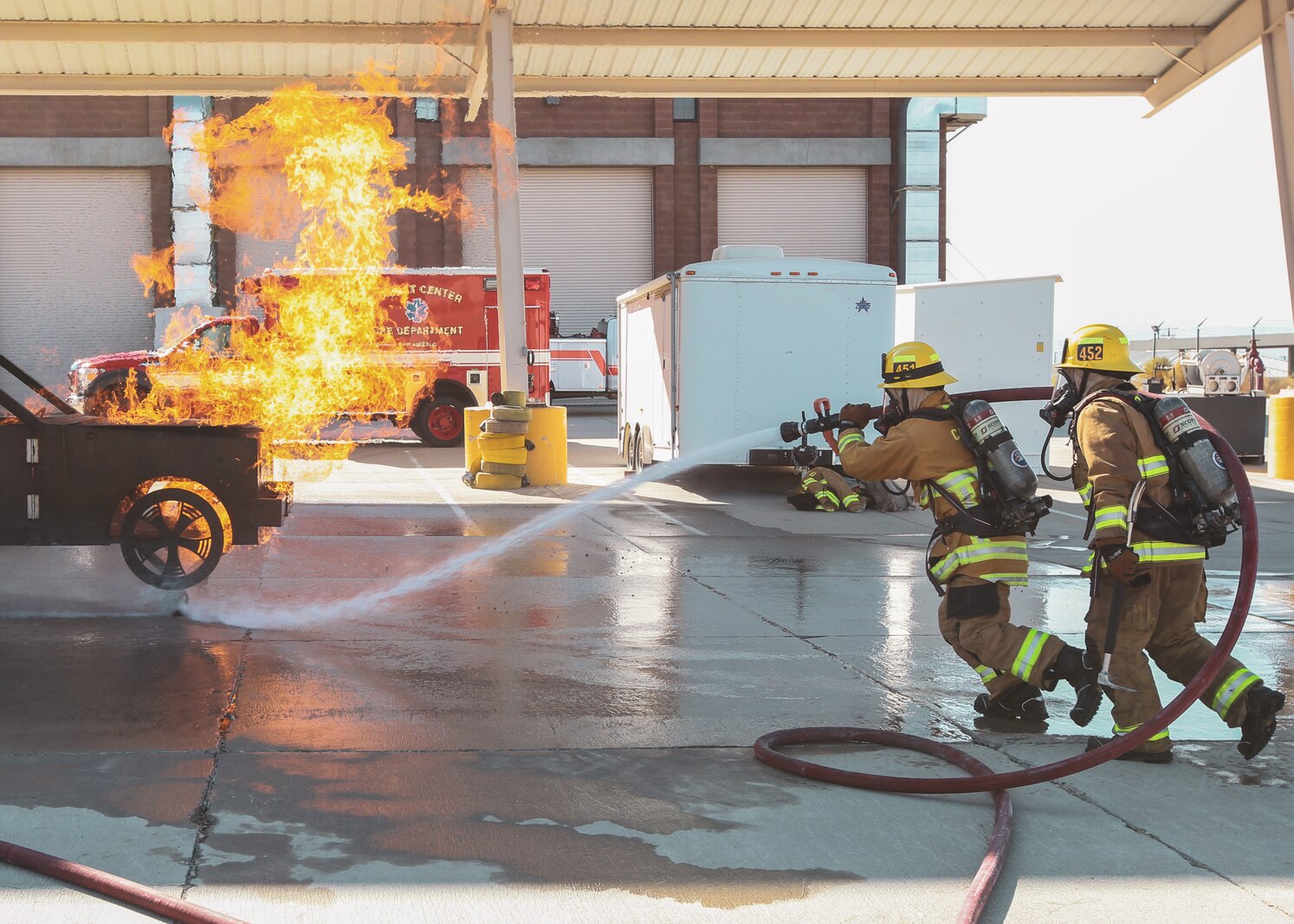firefighters with the Combat Center Fire Department conduct vehicle fire drills