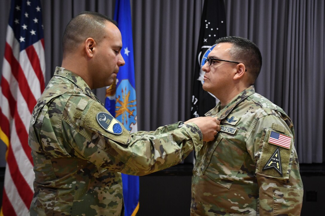 Lt. Col. William Hassey, outgoing 13th Space Warning Squadron commander, is presented a Meritorious Service Medal by Col. Miguel Cruz, Space Delta 4 commander, during the Squadron Change of Command at Clear Space Force Station, June 16, 2022. (U.S. Air National Guard photo by Senior Master Sgt. Julie Avey)