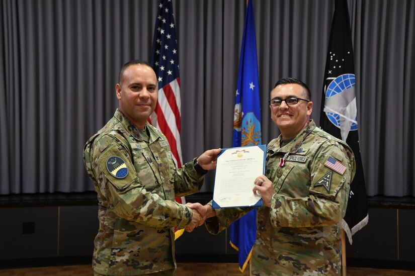 Lt. Col. William Hassey, outgoing 13th Space Warning Squadron commander, is presented a Meritorious Service Medal by Col. Miguel Cruz, Space Delta 4 commander, during the Squadron Change of Command at Clear Space Force Station, June 16, 2022. (U.S. Air National Guard photo by Senior Master Sgt. Julie Avey)