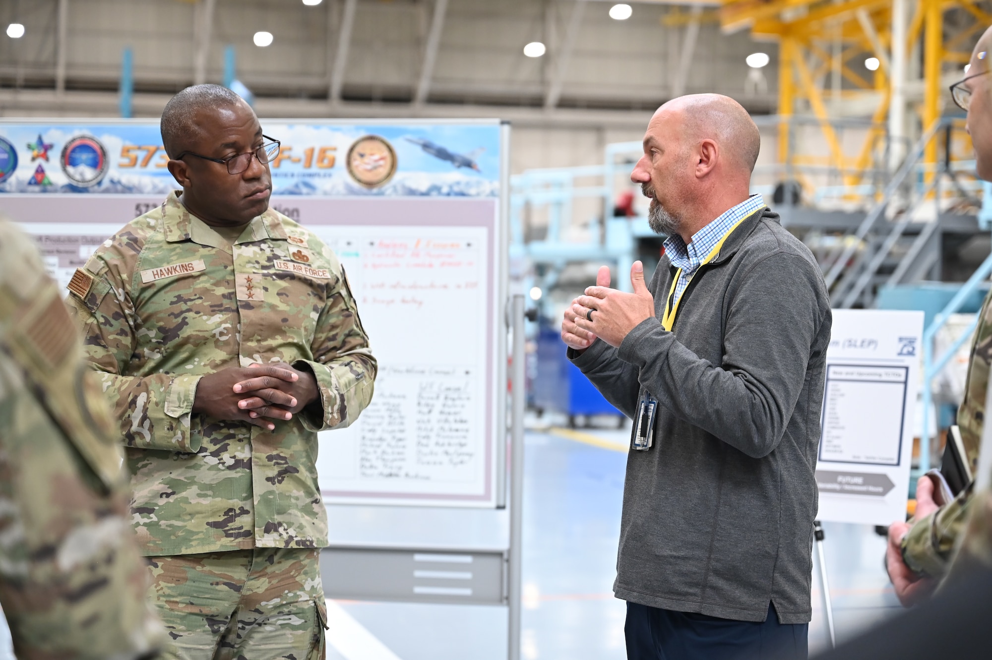 Lt. Gen. Stacey Hawkins, Air Force Sustainment Center commander, listens to Chad Lessey, 573rd Aircraft Maintenance Squadron brief about the F-16 program during a base visit Nov. 16, 2022, at Hill Air Force Base, Utah. (U.S. Air Force photo by Cynthia Griggs)