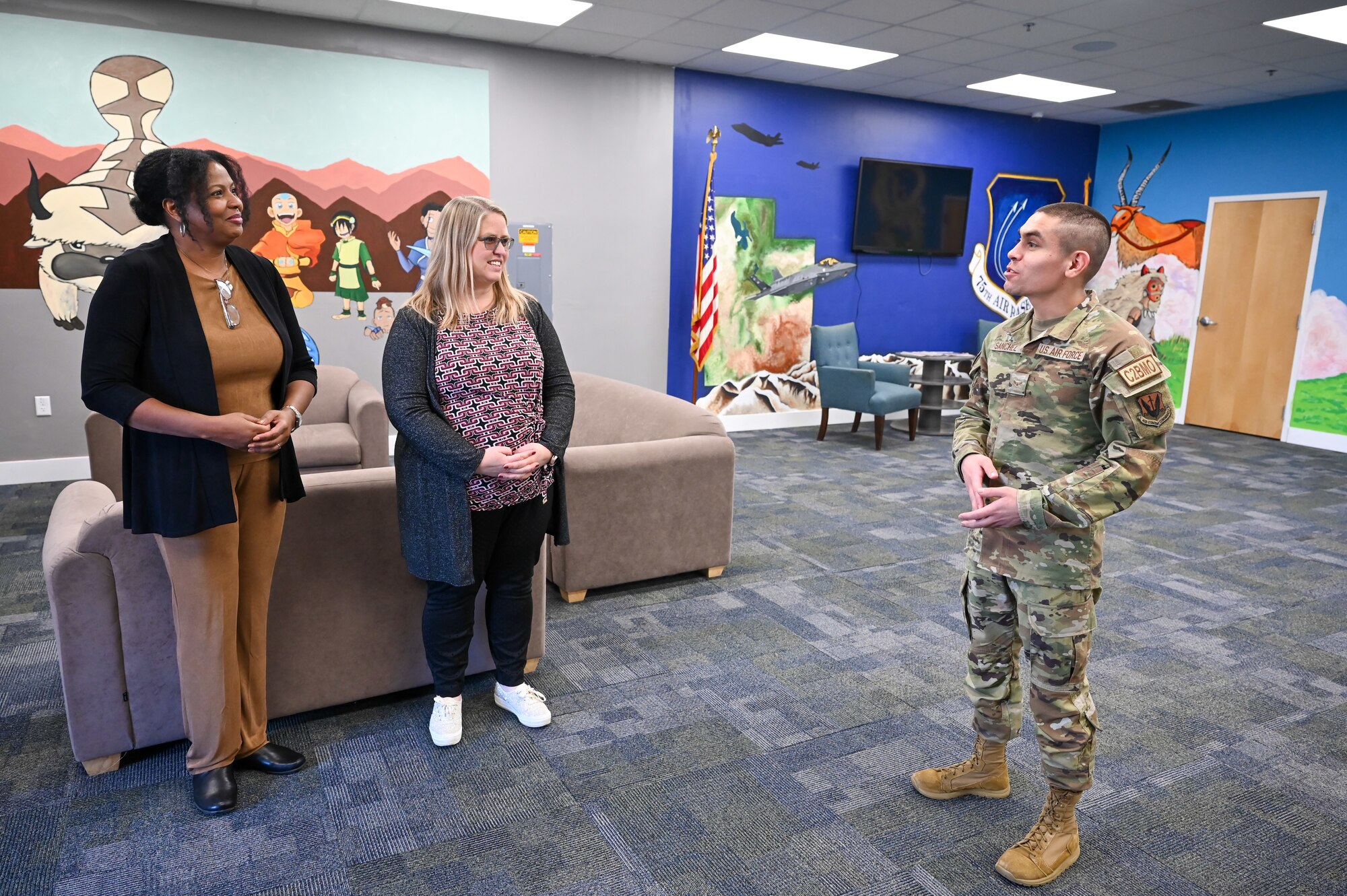 Natalie Hawkins (left), spouse of Air Force Sustainment Center Commander Lt. Gen. Stacey Hawkins, and Tammy Holland, spouse of 75th Air Base Wing Commander Col. Jeffrey Holland, 7, receive a tour of the Airmen Recreation Center from Airman 1st Class Xavier Sanchez, ARC manager, during a base visit Nov. 17, 2022, at Hill Air Force Base, Utah. (U.S. Air Force photo by Cynthia Griggs)