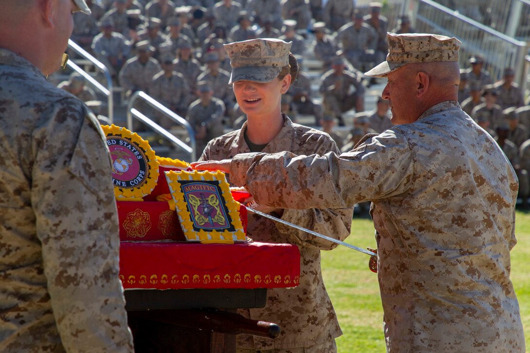 U.S. Marine Corps Maj. Gen. Austin Renforth, commanding general, Marine Air Ground Task Force Training Command, Marine Corps Air Ground Combat Center (MCAGCC), cuts a piece of cake during the Marine Corps historical uniform pageant at MCAGCC, Twentynine Palms, California, Nov. 9, 2022. The event included a historical uniform pageant and the traditional cake cutting ceremony in honor of the 247th Marine Corps birthday. (U.S. Marine Corps photo by Lance Cpl. Jacquilyn Davis)