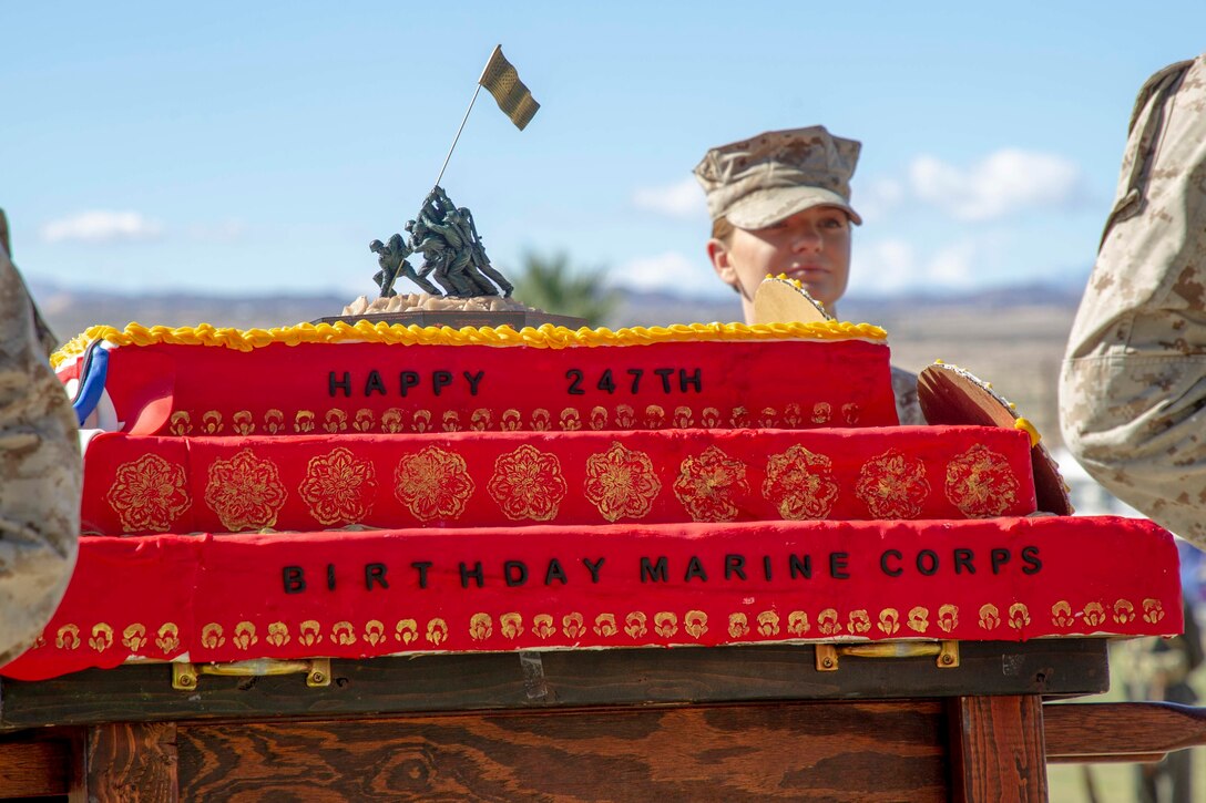 U.S. Marines with Headquarters Battalion, Marine Corps Air Ground Combat Center (MCAGCC), present the Marine Corps birthday cake during the Marine Corps historical uniform pageant at MCAGCC, Twentynine Palms, California, Nov. 9, 2022. The event included a historical uniform pageant and the traditional cake cutting ceremony in honor of the 247th Marine Corps birthday. (U.S. Marine Corps photo by Lance Cpl. Jacquilyn Davis)