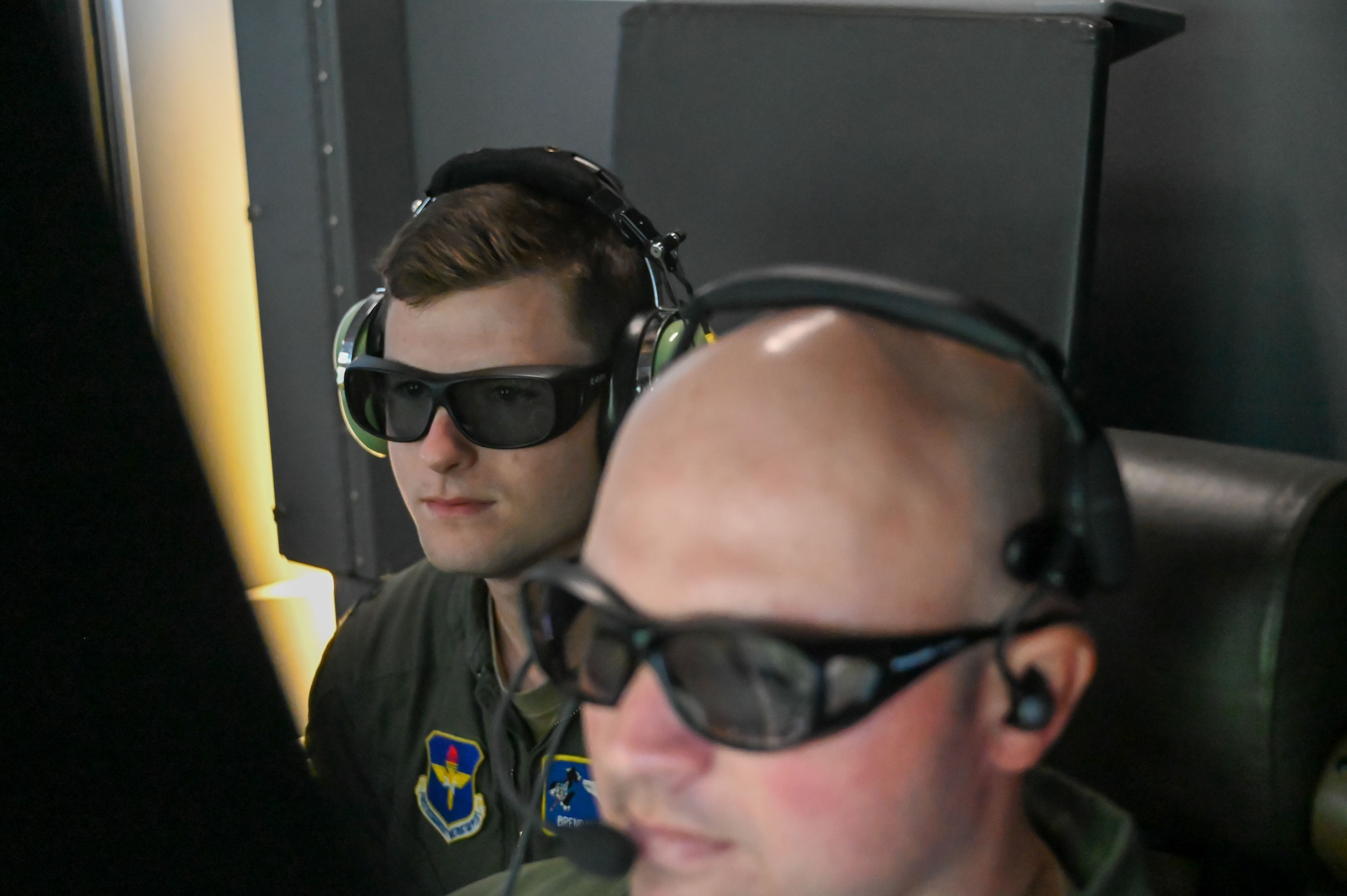 U.S. Air Force Capt. Brendan Bailey, 48th Flying Training Squadron instructor pilot, watches as Senior Master Sgt. Christopher Yontz, 56th Air Refueling Squadron boom operator instructor, refuels a C-17 Globemaster III in Nebraska airspace, Nov. 26, 2022. The KC-46 Pegasus has a fuel capacity of more than 212,000 pounds. (U.S. Air Force photo by Senior Airman Kayla Christenson)
