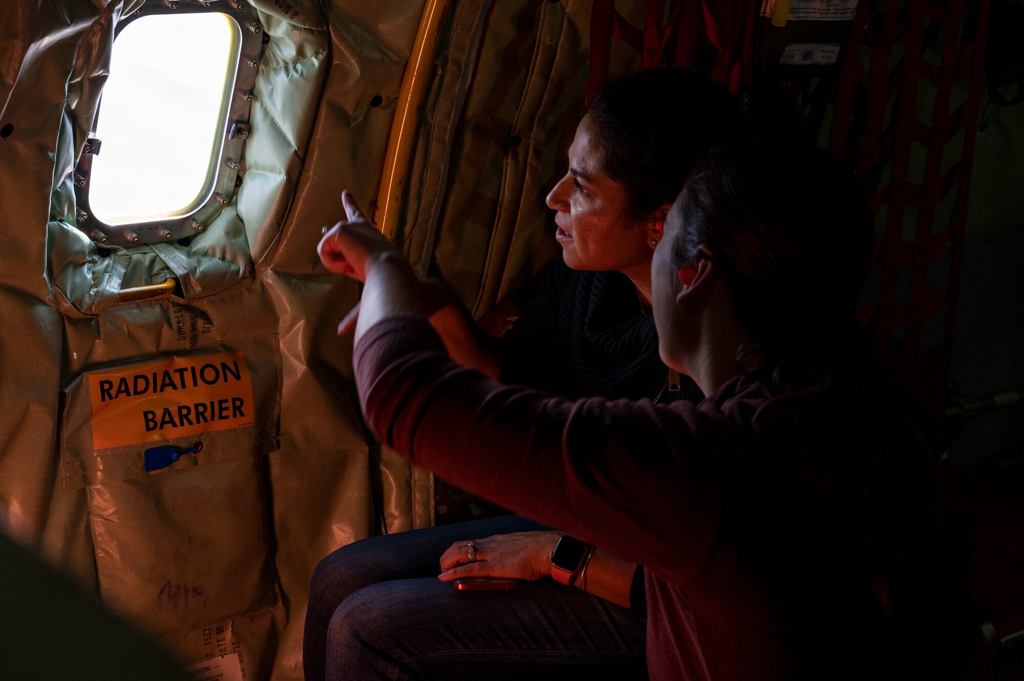 Desi Brown, a 311th Fighter Squadron member’s spouse, left, and Katie Depaola, a 311th Fighter Squadron member's spouse, look out the window of a KC-135 Stratotanker from the 121st Air Refueling Wing at Rickenbacker Air National Guard Base, Columbus, Ohio, Nov. 15, 2022.