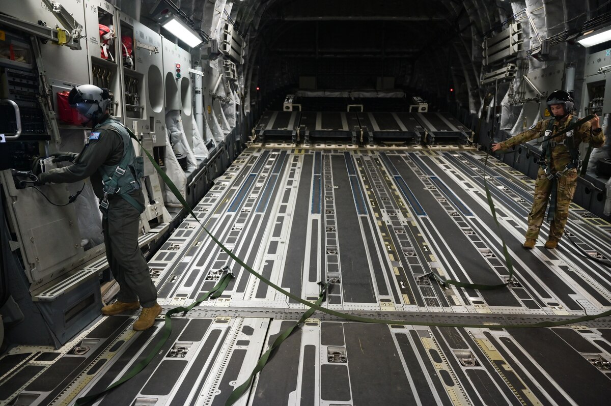 Royal Australian Air Force Corporal Shawn Harding, No. 36 Squadron loadmaster, and U.S. Air Force Senior Airman Jo Besse, 535th Airlift Squadron loadmaster, prepare to lower a ramp on a RAAF C-17 Globemaster III during Exercise Global Dexterity in the skies over Queensland, Nov. 14, 2022. Exercise Global Dexterity 2022 is being conducted at RAAF Base Amberley, and is designed to help develop the bilateral tactical airlift and airdrop capabilities of the United States Air Force (USAF) and the Royal Australian Air Force (RAAF). Both the United States and Australia rely on the C-17A to provide strategic and tactical airlift across the Indo-Pacific region, with its ability to provide short-notice and time-critical airlift support making it essential during humanitarian assistance and disaster relief operations. (U.S. Air Force photo by Staff Sgt. Alan Ricker)