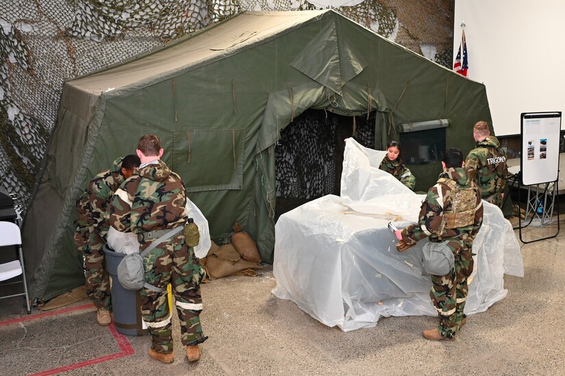 People dressed in chemical protective gear