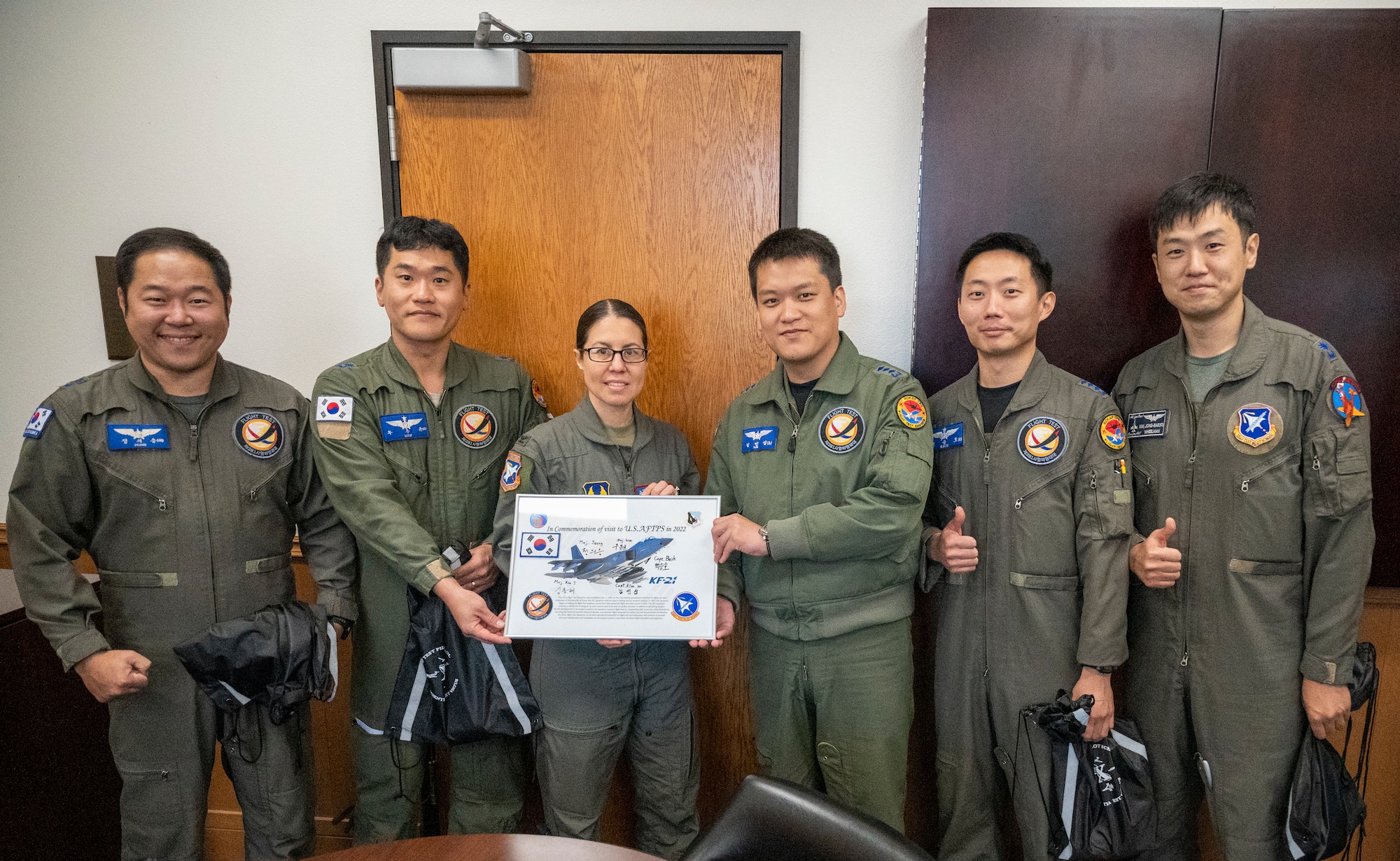 Col. Sebrina Pabon, Commandant, U.S. Air Force Test Pilot School presents a Commemoration of Visit certificate to the Republic of Korean Air Force (ROKAF) team after a successful technical exchange.