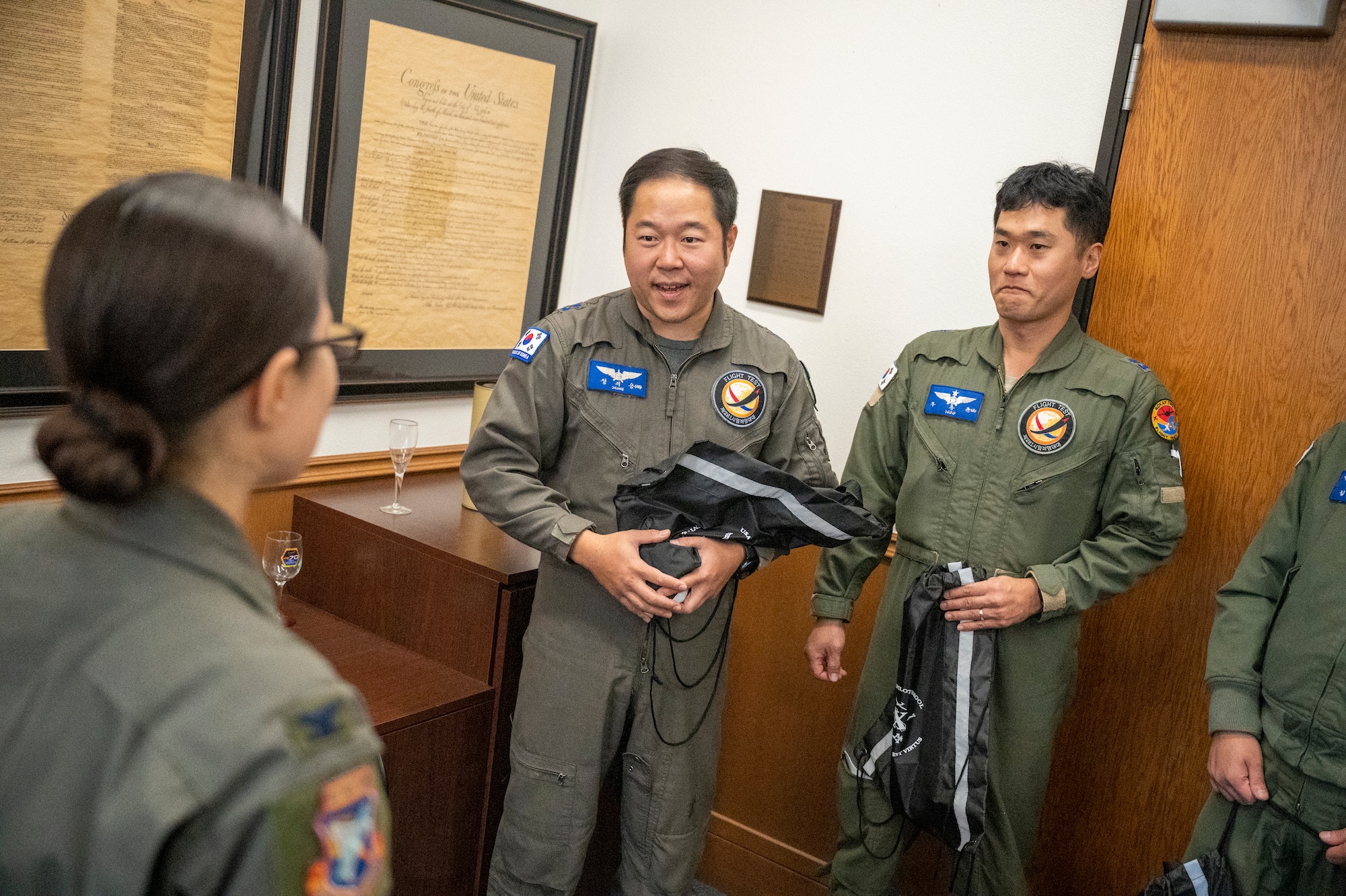 Col. Sebrina Pabon, Commandant, U.S. Air Force Test Pilot School presents a parting gift to the Republic of Korean Air Force (ROKAF) team after a successful technical exchange.