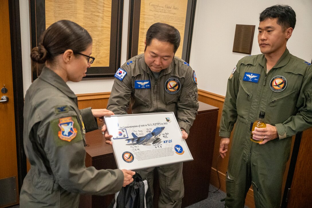 Col. Sebrina Pabon, Commandant, U.S. Air Force Test Pilot School presents a Commemoration of Visit certificate to the Republic of Korean Air Force (ROKAF) team after a successful technical exchange.
