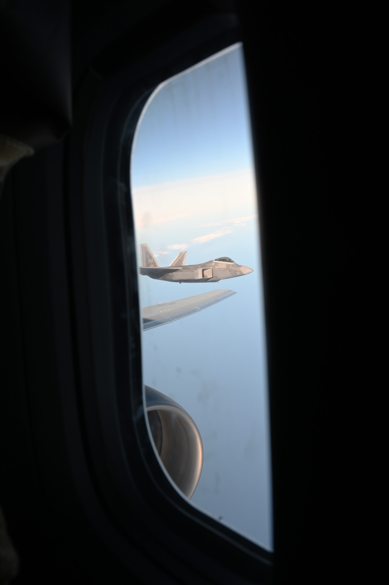 An F-22 Raptor waits for gas just off the wingtip of a KC-46A Pegasus aerial refueler from the 157th Air Refueling Wing, Nov. 16, 2022.