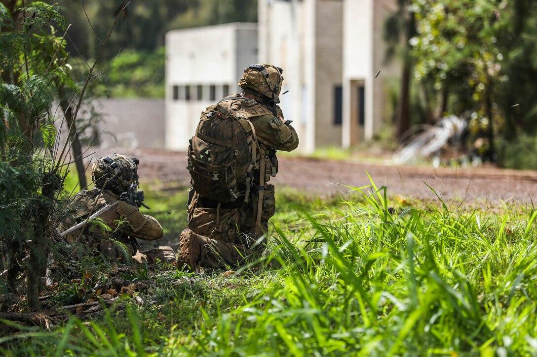 A Soldier from the 25th Infantry Division simulates a fire attack and returns fire to opposing forces during the Joint Pacific Multi-National Readiness Center rotation 22-01 exercise on Kahuku Training Area, Hawaii on Oct. 25, 2021. JPMRC Rotation 22-01 provides the 25th Infantry Division the opportunity to integrate and train alongside our partners and allies throughout the Indo-Pacific Region. (U.S. Army photo by Sgt. Carlie Lopez/28th Public Affairs Detachment)