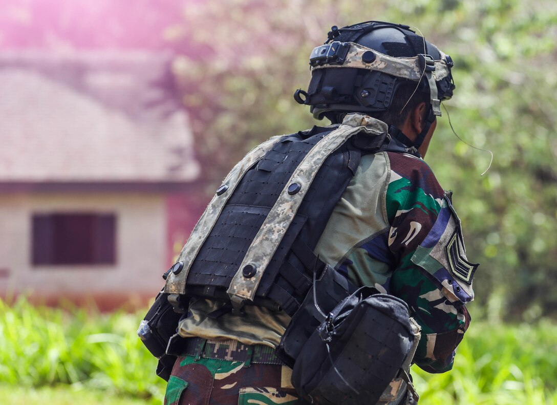 A Soldier from the Indonesian National Army simulates a fire attack and scans a sector of fire during the Joint Pacific Multi-National Readiness Center rotation 22-01 exercise on Kahuku Training Area, Hawaii on Oct. 25, 2021. JPMRC Rotation 22-01 provides the 25th Infantry Division the opportunity to integrate and train alongside our partners and allies throughout the Indo-Pacific Region. (U.S. Army photo by Sgt. Carlie Lopez/28th Public Affairs Detachment)