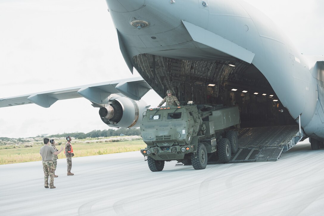 A U.S. Army Soldier assigned to Bravo Battery, 1st Battalion, 94th Field Artillery Regiment, 17th Field Artillery Brigade out of Joint Base Lewis-McChord, Wash., stands tall in the hatch of a Hight Mobility Artillery Rocket System vehicle and directs the driver off the tarmac on Andersen Air Force Base, Guam, Sept. 26, 2022.