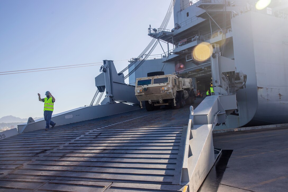The first vehicle from Army Prepositioned Stock-3, also known as APS Afloat, is driven off the U.S. Naval Ship Red Cloud. The download of APS Afloat in support of Salaknib 22 is the first APS Afloat operation in the Indo-Pacific Theater. (U.S. Army photo by Katie Nelson, 402nd Army Field Support Brigade)