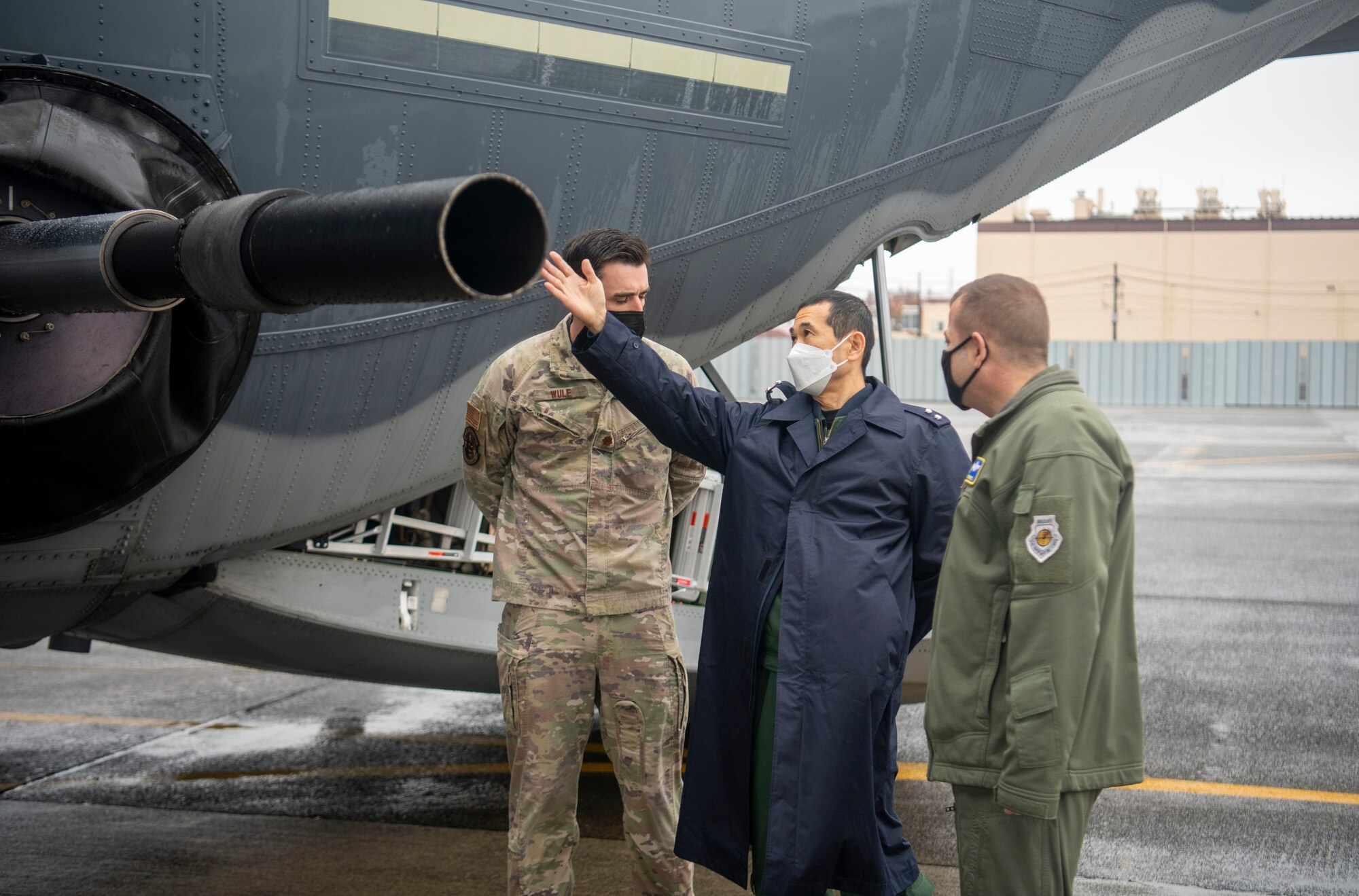 U.S. Air Force Maj. Mark Wulf, 17th Special Operations Squadron chief of tactics (left), speaks with Japan Air Self-Defense Force Maj. Gen. Takayuki Terasaki, Air Defense Command defense plans and operations director (middle), and U.S. Air Force Brig. Gen. Jesse J. Friedel, 5th Air Force deputy commander (right), about the capabilities of the AC-130J Ghostrider during Keen Sword 23 at Yokota Air Base, Japan, Nov. 15, 2022.