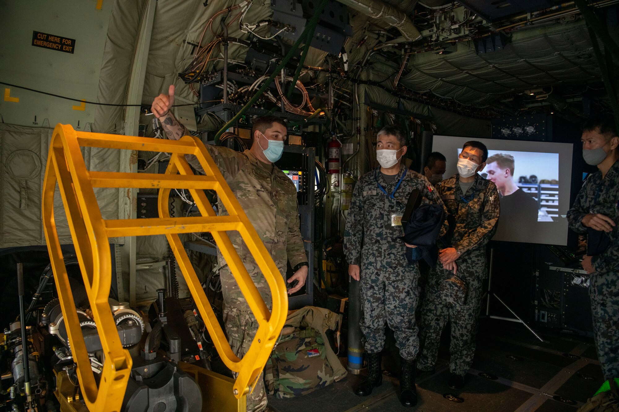 U.S. Air Force Staff Sgt. Alain Haldeman, 17th Special Operations Squadron AC-130J Ghostrider aerial gunner, briefs Japan Air Self-Defense Force members on the weapon systems inside an AC-130J during Keen Sword 23, Yokota Air Base, Japan, Nov. 15, 2022.