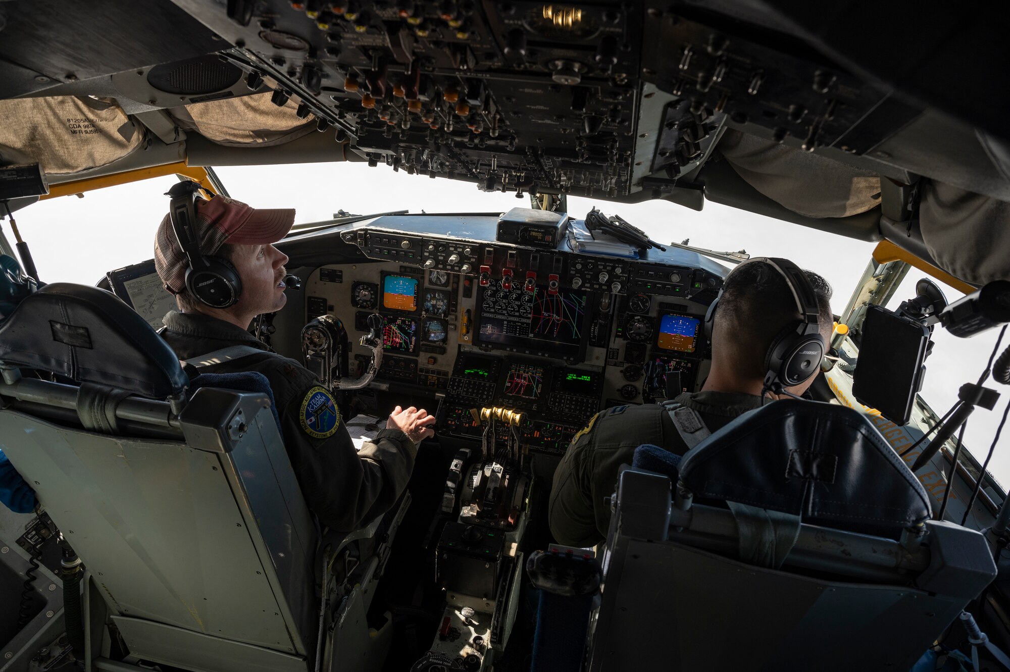 U.S. Air Force Maj. Myles Berthold, left, and Capt. Dustin Alger, 909th Air Refueling Squadron pilots, look out the window during a flight over the Pacific Ocean in support of exercise Keen Sword 23, Nov. 17, 2022. Bilateral exercises demonstrate the U.S. and Japan’s strong, shared commitment to a free and open Indo-Pacific. (U.S. Air Force photo by Senior Airman Jessi Roth)