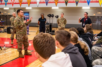 A guitarist from Band of Flight, Wright-Patterson Air Force Base, Ohio, speaks with jazz band students at Holly High School.