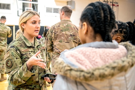 recruiter, center, speaks to Air Force JROTC students at Robichaud High School, Dearborn Heights, Michigan