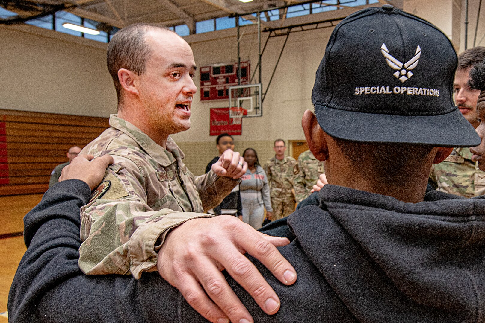 U.S. Air Force Tech. Sgt. Scott Mendenhall, 330th Recruiting Squadron special warfare recruiter, joins a circle of students to play a game