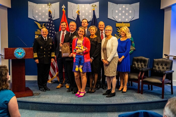 WASHINGTON (November 17, 2022) -  Chief of Naval Operations Adm. Mike Gilday presents Cmdr. John W. Keefe, commanding officer, Explosive Ordnance Disposal Mobile Unit Five (EODMU 5), with the 2022 Vice Admiral James Bond Stockdale Leadership Award during a ceremony held in the Hall of Heroes at the Pentagon, November 17, 2022. The Stockdale Leadership Award is presented annually to recognize commanding officers, one from the Pacific Fleet and one from the Atlantic Fleet, who demonstrate inspirational leadership, both professionally and personally, while also contributing to the improvement of leadership in the Navy. (U.S. Navy photo by Mass Communication Specialist 1st Class Michael B. Zingaro/released)