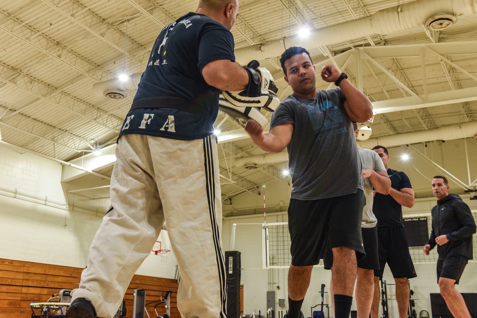 Staff Sergeant David Correa practices punching drills with other 108th Wing Airmen in the McGuire Fitness Center.