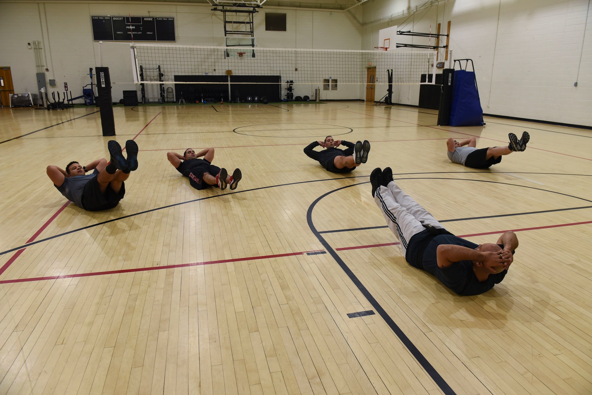 Five Airmen from the 108th Wing engage in team exercise in the McGuire Fitness Center.
