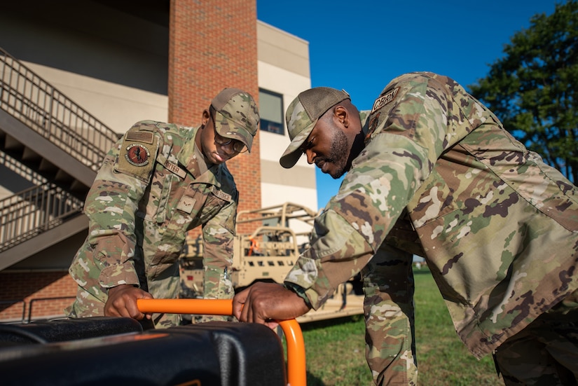 Airman 1st Class Brandon Porter, left, and Master Sgt. Kevin Woodard from the Kentucky Air National Guard’s Fatality Search and Recovery Team inspect a generator used in recovery operations during training at the 123rd Airlift Wing in Louisville, Ky., Sept. 8, 2022. The FSRT, part of the 123rd Force Support Squadron, assisted local coroners during historic flooding in Eastern Kentucky this summer. (U.S. Air Force photo by Phil Speck)