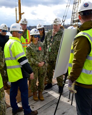 Vice Chief of Naval Operations Adm. Lisa Franchetti (center) is briefed on Shipyard Infrastructure Optimization Program projects underway at the shipyard during a visit Nov. 17, 2022.