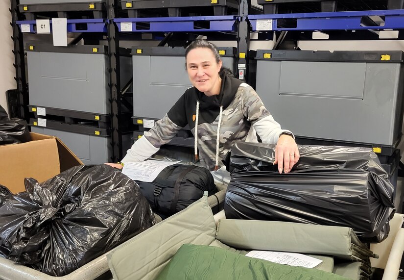 Emina Pecanin is a Logistics Readiness Center Wiesbaden Central Issue Facility supply technician, 405th Army Field Support Brigade. Pictured here, Pecanin sorts through CIF clothing and equipment at the Wiesbaden facility, Nov. 16, preparing it for turn-in to the Defense Logistics Agency in Kaiserslautern, Germany. Pecanin said making the decision to move from her home country of Croatia to Germany wasn’t easy, but five years later she’s glad she did. (U.S. Army Courtesy photo)