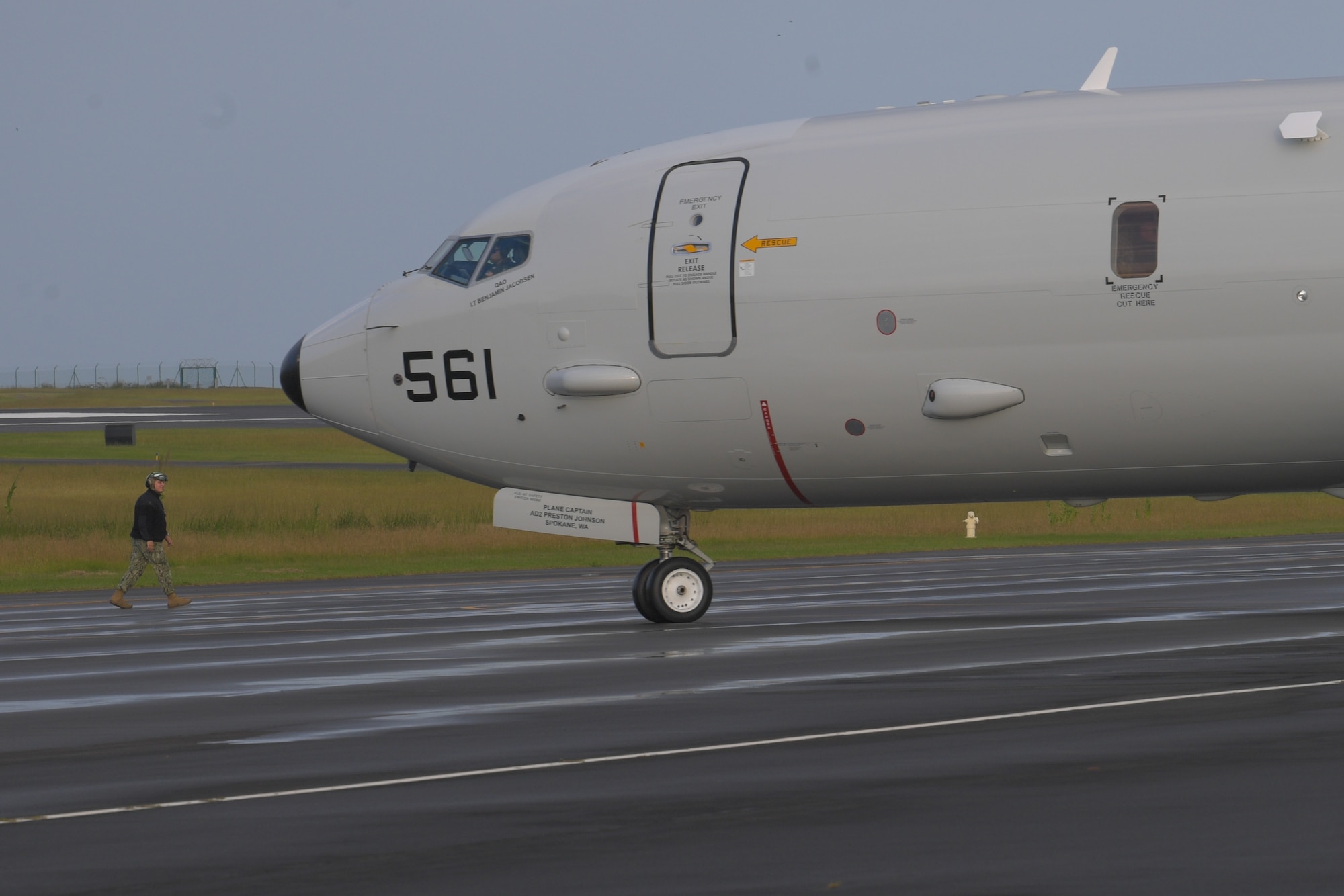 man directs plane