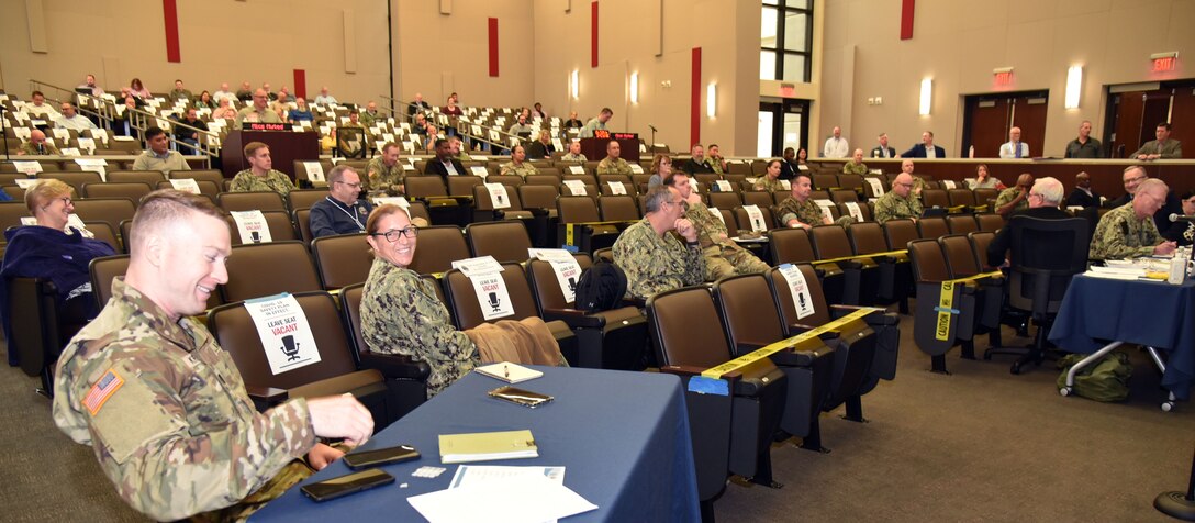 People in an auditorium conference room.