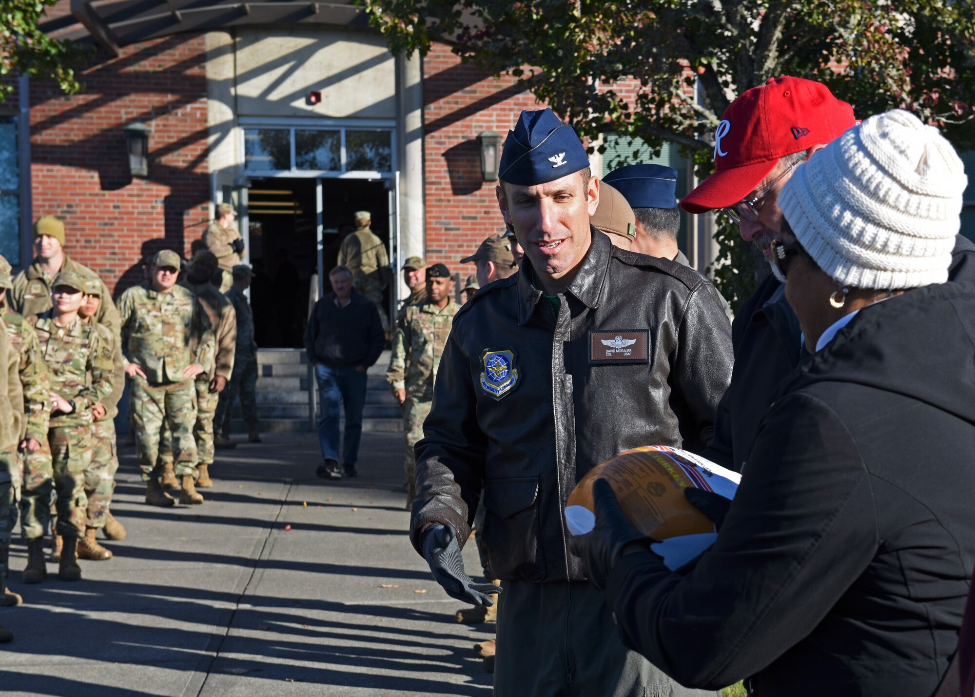 U.S. Air Force Col. David Morales, vice commander of the 62d Airlift Wing, helps pass the first turkey during Team McChord’s annual Operation Turkey Drop at Joint Base Lewis-McChord, Washington, Nov. 18, 2022. Hundreds of turkeys, gift cards and additional food items were donated by the Air Force Association Washington State Chapter, Pierce Military and Business Alliance, the Army and Air Force Exchange Service and the Religious Support Office to provide to Airmen in time for Thanksgiving. (U.S. Air Force photo by Staff Sgt. Zoe Thacker)