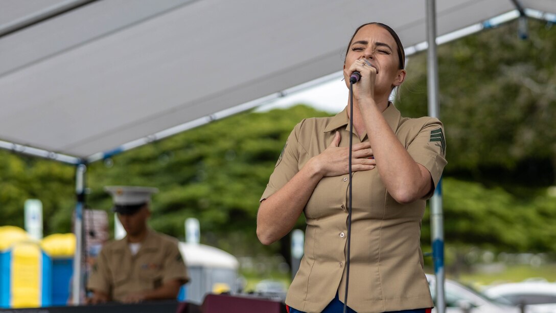 U.S. Marine Corps Sgt. Ashley V. Cook, musician, U.S. Marine Corps Forces, Pacific Band, performs "God Bless the U.S.A. " during a Veterans Day Ceremony at the National Memorial Cemetery of the Pacific in Honolulu, Hawaii, November 11, 2022. Veterans Day began as Armistice Day, honoring the end of World War I. Veterans Day pays tribute to all American veterans, living or dead, who served their country honorably during war or peacetime. This ceremony was presented by the Oahu Veterans Council. (U.S. Marine Corps photo by Cpl. Haley Fourmet Gustavsen)