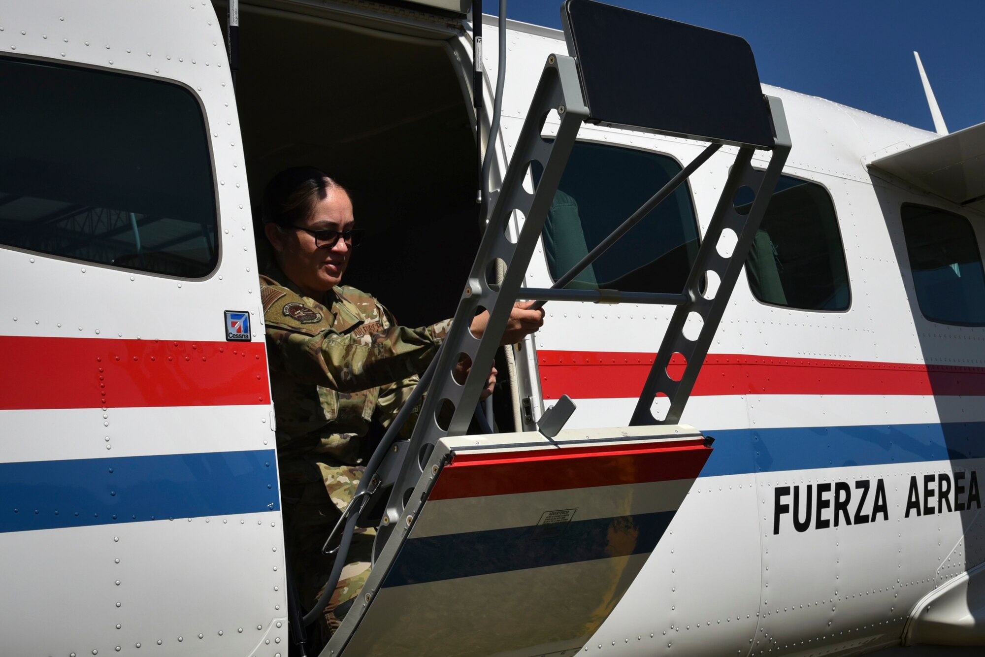 U.S. Air Force Master Sgt. Ana Mendiola, the 571st Mobility Support Advisory Squadron (MSAS) training flight chief, closes the door of a Cessna 402 aircraft, Sept. 15, 2022, in Paraguay. The 571st MSAS visited Paraguay to train their Air Force and build partnership capacity. During their visit, the first flight between the two Air Force units was operated and completed solely by an all-female aircrew and led by a female Paraguayan pilot. (Courtesy Photo)