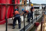 Coast Guard Cutter Patoka crew loads cement weights on board Coast Guard Cutter Patoka Oct. 24, 2022 at Ensley Engineer Yard near Memphis, Tennessee. The Patoka is responding to low water by assisting with aids to navigation on the Mississippi river. (U.S. Coast Guard photo by Petty Officer 3rd Class James Hague)