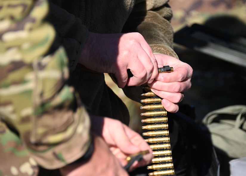An Airman gathers bullets in preparation for Tactical Combat Casualty Care training at Joint Base Andrews, Md., Nov. 18, 2022. The TCCC training consisted of moving towards injured victims, then performing proper emergency care methods and evacuation by helicopter. (U.S. Air Force photo by Airman 1st Class Austin Pate)