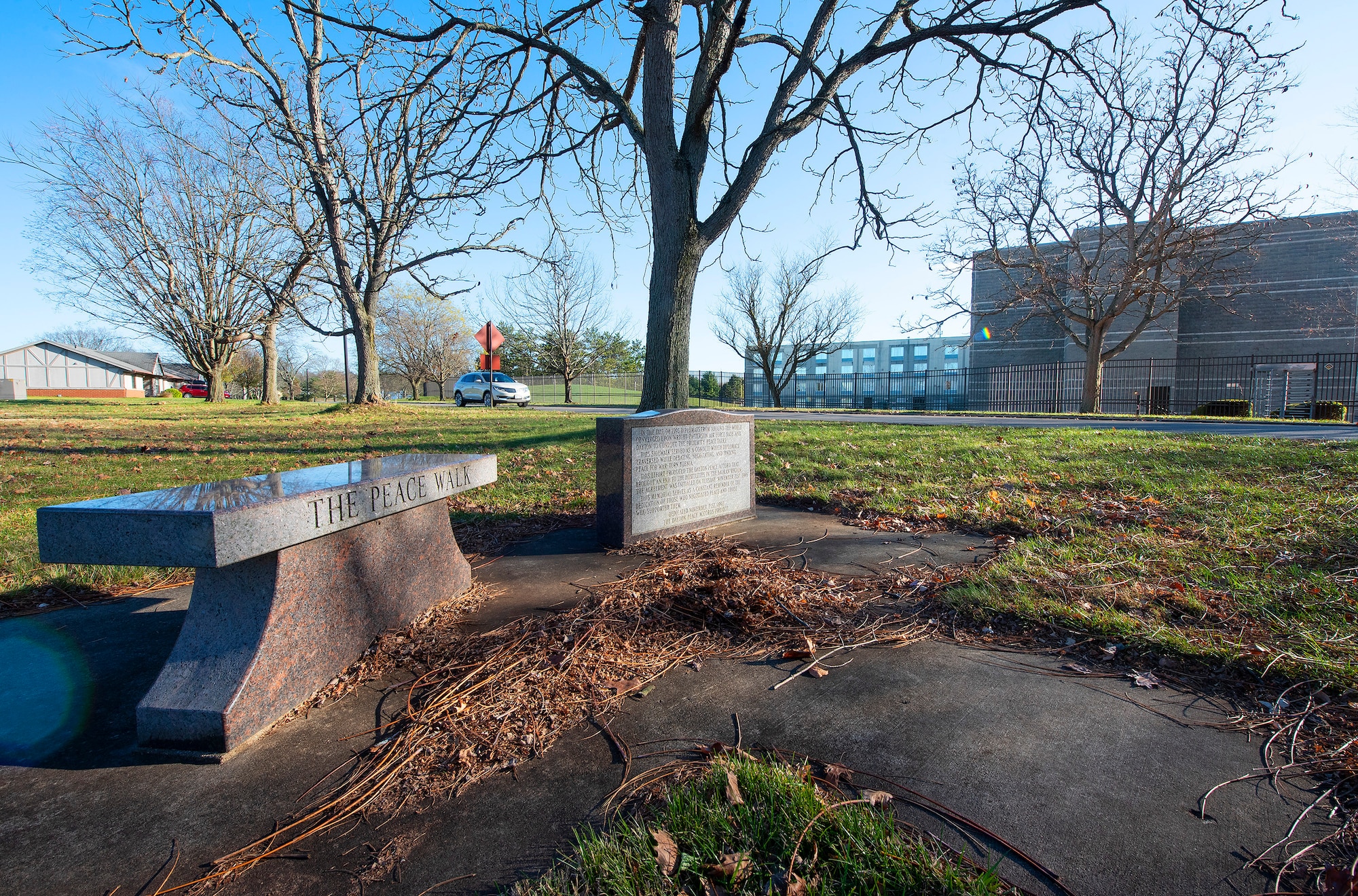 A bench and plaque commemorate The Peace Walk, a winding sidewalk between the Hope Hotel near WPAFB.