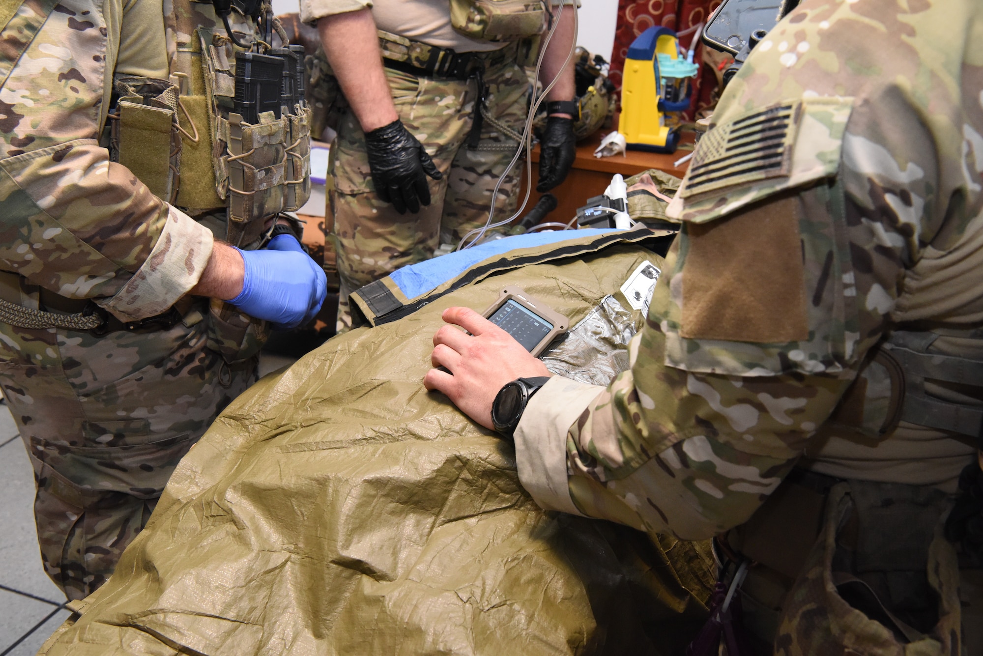 U.S. Air Force Pararescuemen conduct prolonged casualty care to a severely wounded mannequin.