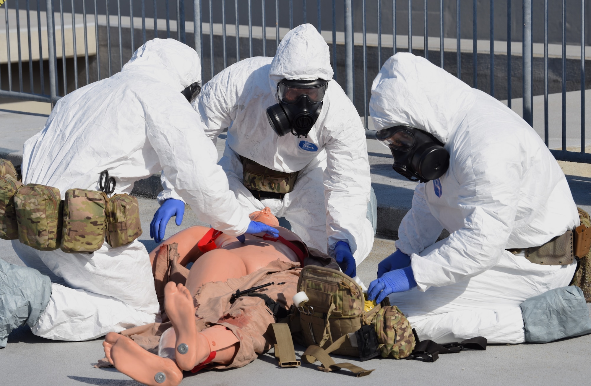 U.S. Air Force Pararescuemen conduct trauma care to a wounded mannequin.