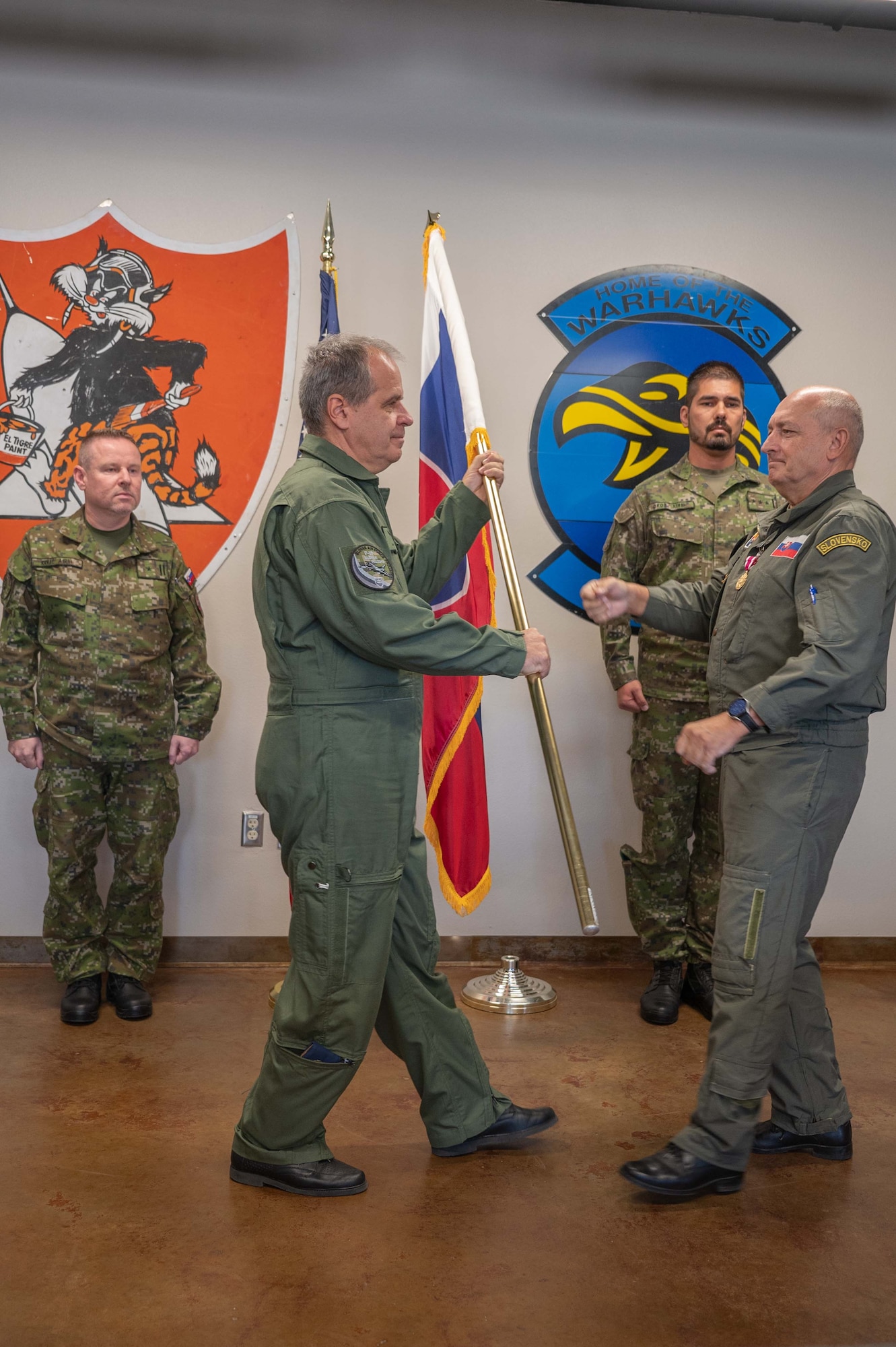 Slovak air force Colonel Adolf Ulicny receives the Slovakian flag from Colonel Tomas Novotny as a symbol of his assumption of duties as the new Slovak Foreign Liaison Officer in a ceremony here today at Morris Air National Guard Base, Ariz. (U.S. Air National Guard photo by Maj. Angela Walz)