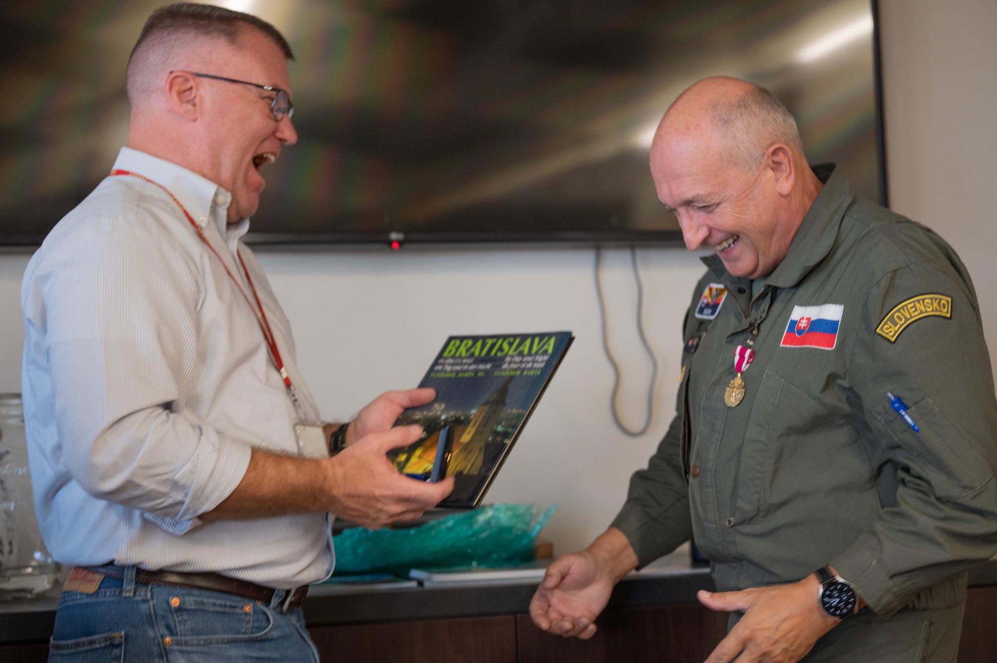 Mr. Michael Neighbors, 162nd Wing International Affairs, and Slovak air force Col. Tomas Novotny, outgoing Liaison Officer, exchange laughs and mementos during a recent ceremony at Morris Air National Guard Base, Ariz. (U.S. Air National Guard photo by Maj. Angela Walz)