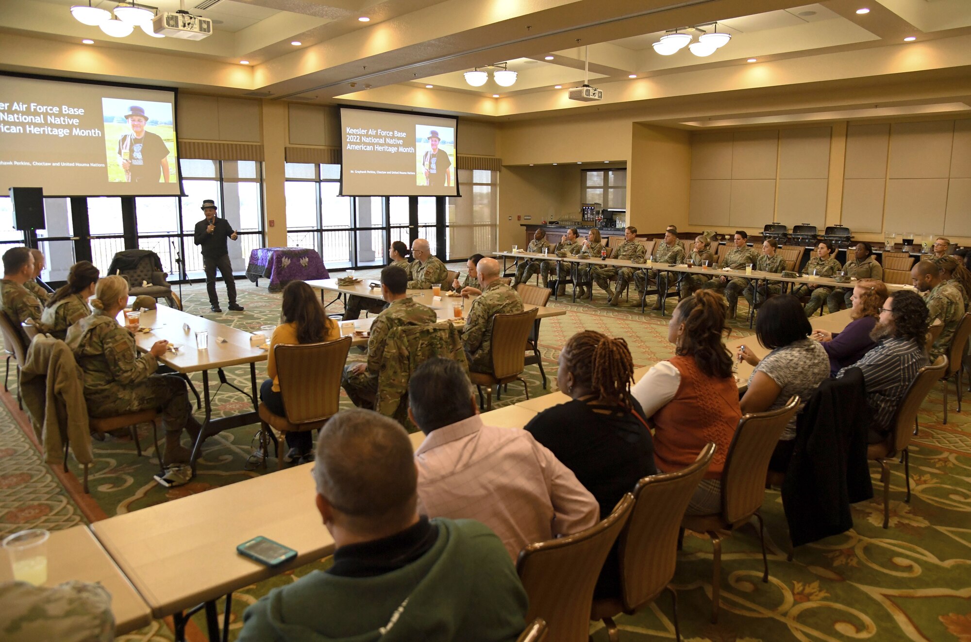 Grayhawk Perkins delivers remarks inside the Bay Breeze Event Center at Keesler Air Force Base, Mississippi, Nov. 21, 2022.