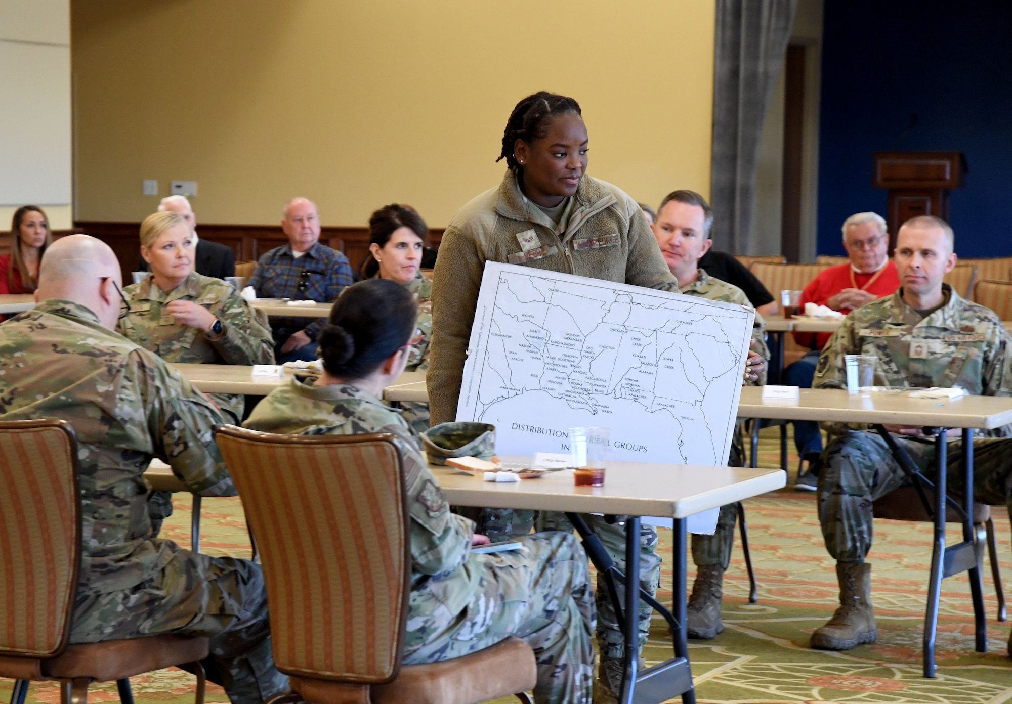 U.S. Air Force Senior Airman Paige Webb, 81st Medical Support Squadron medical logistics technician, shows a map of the distribution of tribal groups in the 1700s during a Native American History Month story telling event inside the Bay Breeze Event Center at Keesler Air Force Base, Mississippi, Nov. 21, 2022.