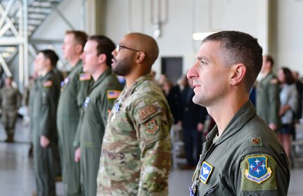 Airmen stand in formation.