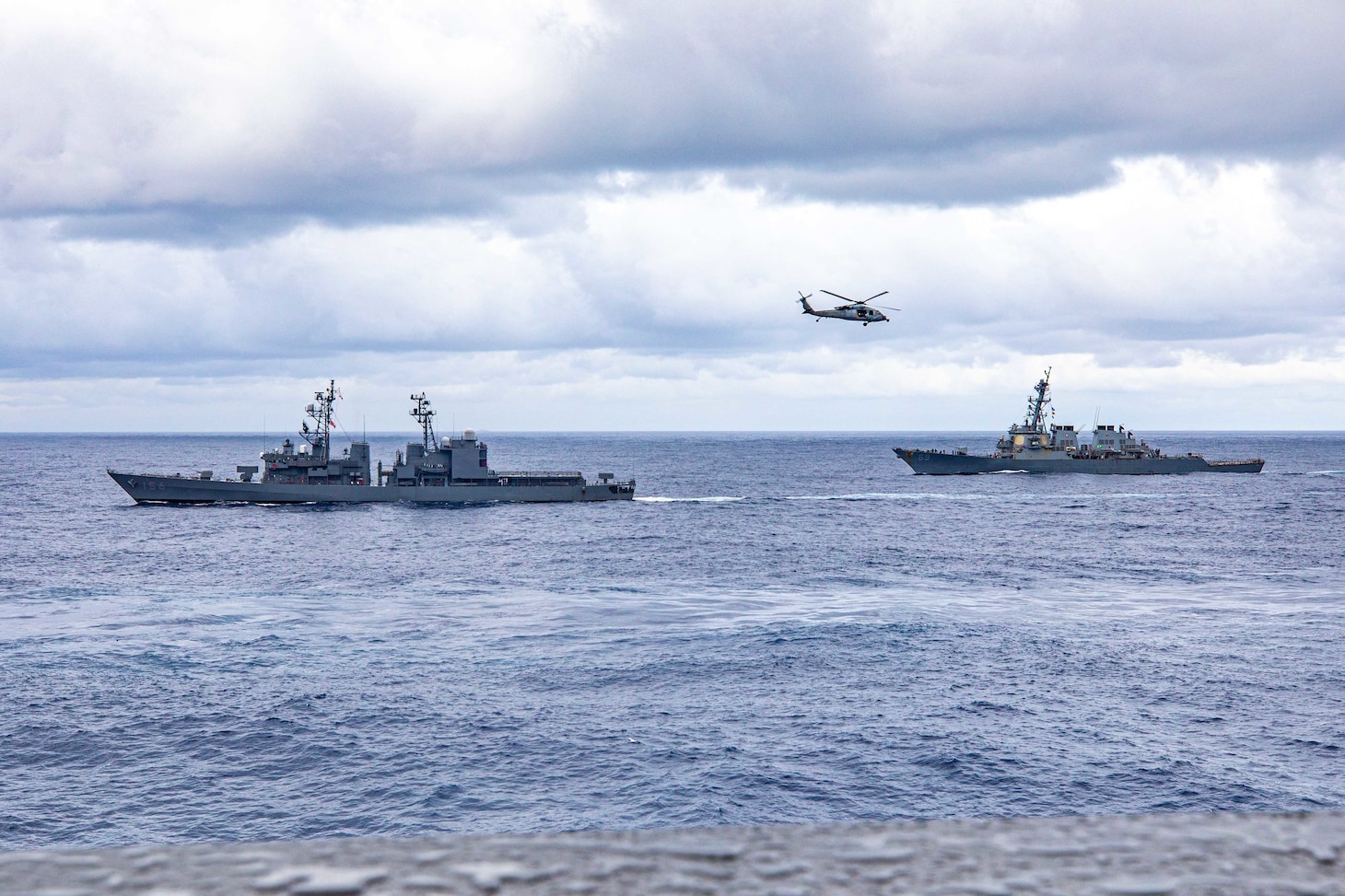 PHILIPPINE SEA (Nov. 20, 2022) USS Chancellorsville (CG 62) along with Carrier Strike Group (CSG) 5 units conduct tri-lateral operations with JS Setogiri (DD 156) of the Japan Maritime Self-Defense Force (JMSDF) and HMAS Stalwart (A304) of the Royal Australian Navy, to focus on allied interoperability training in the areas of sustainment capability and high end warfighting in the Philippine Sea, Nov. 20. Chancellorsville is forward-deployed to the U.S. 7th Fleet in support of security and stability in the Indo-Pacific and is assigned to Commander, Task Force 70, a combat-ready force that protects and defends the collective maritime interest of its allies and partners in the region. (U.S. Navy photo by Mass Communication Specialist 2nd Class Justin Stack)