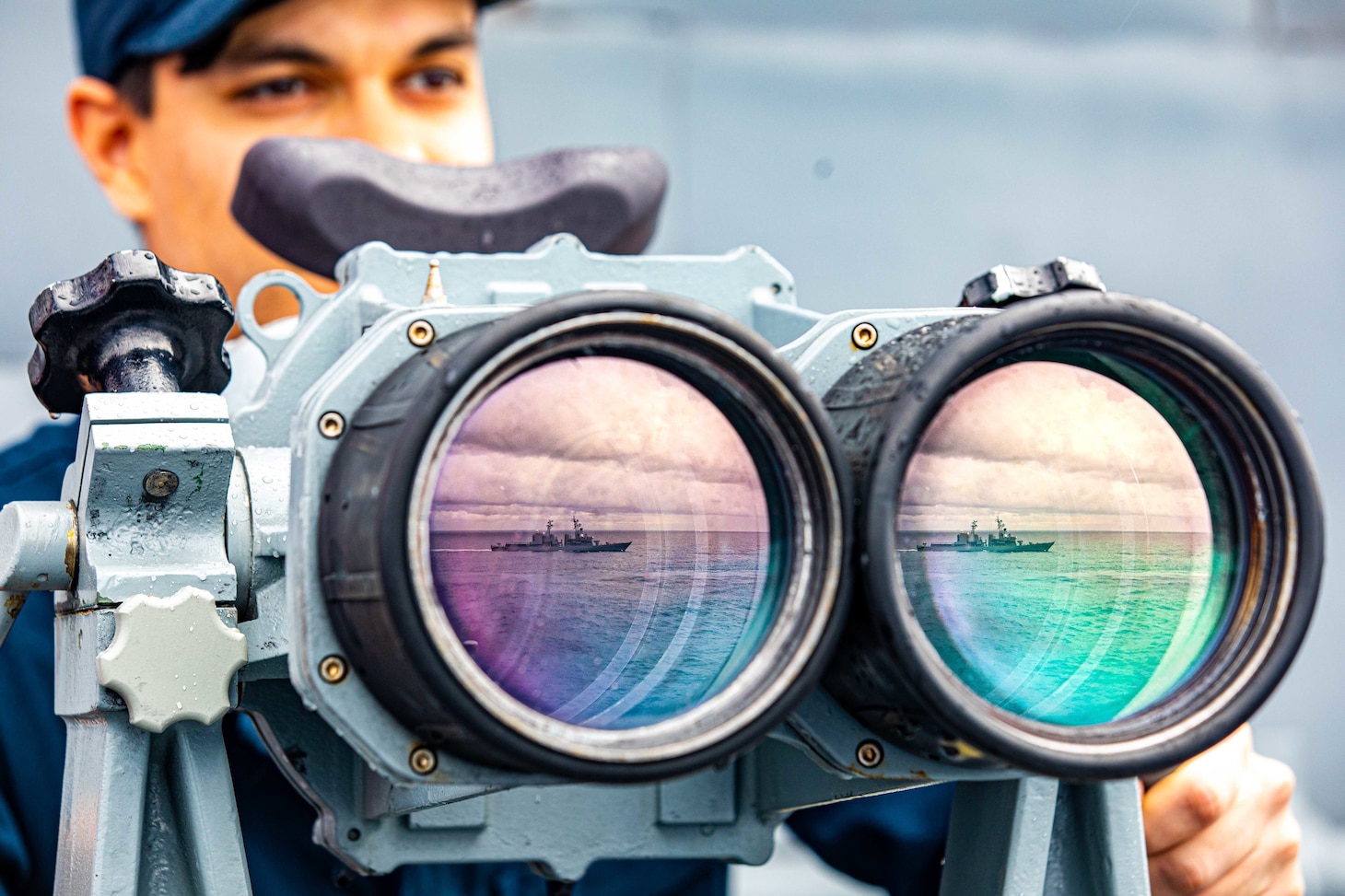 PHILIPPINE SEA (Nov. 20, 2022) Quartermaster Seaman Sean Arnold, from Redding, California, uses the big-eyes on the bridge wing aboard Ticonderoga-class guided-missile cruiser USS Chancellorsville (CG 62) as Carrier Strike Group (CSG) 5 units conduct tri-lateral operations with JS Setogiri (DD 156) of the Japan Maritime Self-Defense Force (JMSDF) and HMAS Stalwart (A304) of the Royal Australian Navy, to focus on allied interoperability training in the areas of sustainment capability and high end warfighting in the Philippine Sea, Nov. 20. Chancellorsville is forward-deployed to the U.S. 7th Fleet in support of security and stability in the Indo-Pacific and is assigned to Commander, Task Force 70, a combat-ready force that protects and defends the collective maritime interest of its allies and partners in the region. (U.S. Navy photo by Mass Communication Specialist 2nd Class Justin Stack)