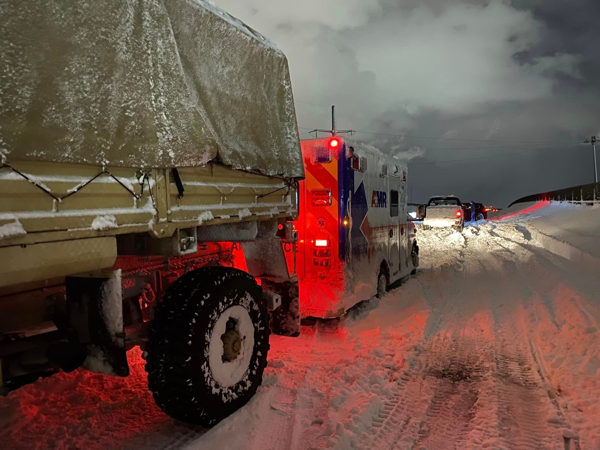 New York National Soldiers from the 2nd Squadron, 101st Cavalry Regiment, help free an EMS vehicle stranded during a snowstorm in Buffalo Nov 19, 2022. Some areas reported over 6 feet of snow.